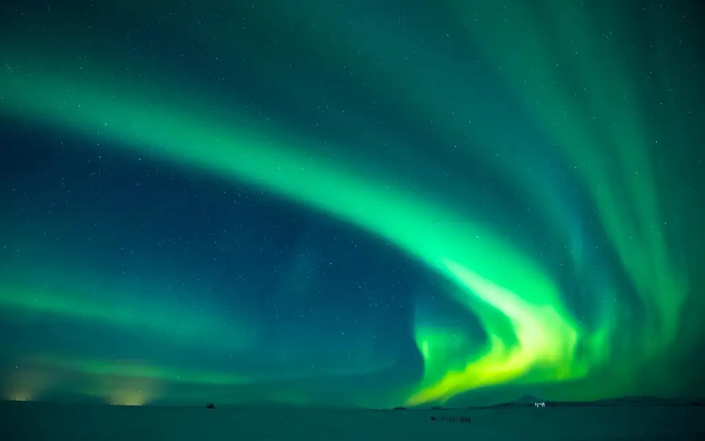 Aurora Borealis spectacular view of the Northern Lights in the sky over Hotel Ranga tourist resort at Hella in South Iceland