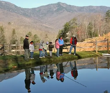 family fishing by pond in Clear Creek Guest Ranch, Burnsville, NC
