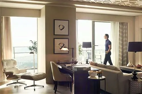 Мужчина смотрит в окно роскошного гостиничного номера в Стамбуле.