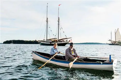 Два человека в лодке в гавани Бруклина