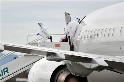 Медицинский персонал помогает погрузить пассажиров с круизного лайнера Grand Princess в самолеты в международном аэропорту Окленда в Окленде, Калифорния, 10 марта 2020 года.