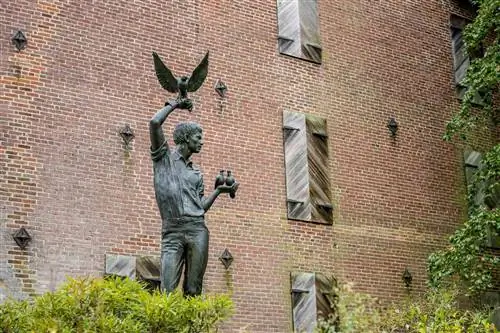 Внешний вид Художественного музея реки Брендивайн со статуей человека с птицами