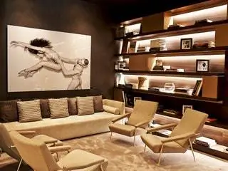 Это изображение может содержать Мебель Комната Гостиная В помещении Стул Кушетка Человек Дизайн интерьера и полка