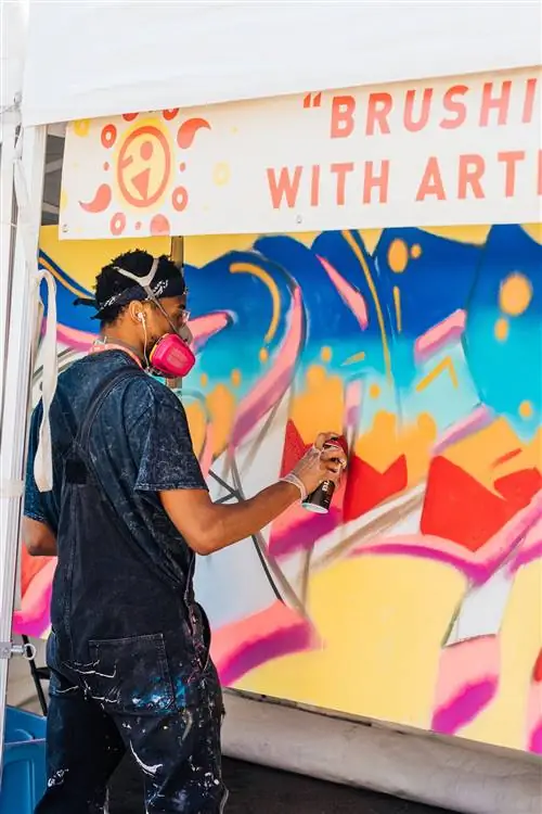 Художник Ник Бернс рисует фреску из баллончика