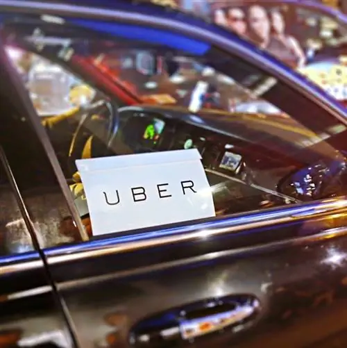 Автосервис Uber на улицах Нью-Йорка в ночное время. С избирательным акцентом на логотипе Uber