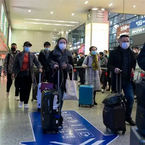 Чэнду, Сычуань, Китай - Все путешественники носят маски в аэропорту, чтобы предотвратить заражение коронавирусом.