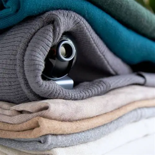 Веб-камера спрятана в стопке одежды для скрытого наблюдения за домом.