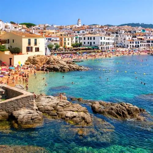 Традиционная побеленная рыбацкая деревня с плавающими лодками и популярное место для путешествий и отдыха на побережье Коста-Брава, Каталония, Испания.