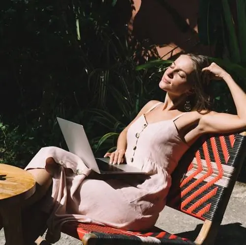 женщина работает за ноутбуком на улице