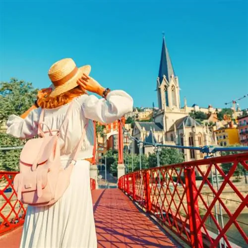 девушка-путешественница и туристка гуляет по центру старого города Лиона и наслаждается видом на церковь Святого Георгия Эглизе на берегу реки Сона копия