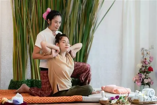 Женщина, получающая тайский массаж в спа-центре для исцеления и расслабления