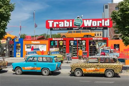Красочные автомобили Trabant припаркованы на улице перед вывеской Trabi World