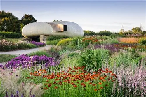 Бетонный павильон Радича в форме раковины в Hauser & Wirth Somerset расположен среди красочного сада с полевыми цветами.