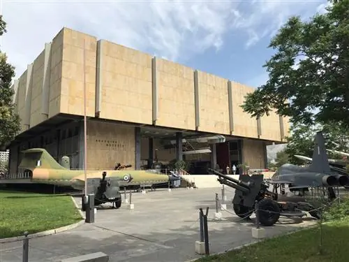 Винтажные истребители стоят возле квадратного здания музея