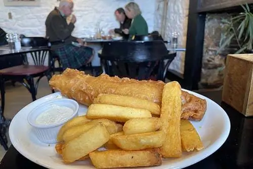 Остановка на обед, чтобы насладиться рыбой с жареным картофелем в Старой библиотеке по пути на борт Jacobite Express, включена в опыт McKinlay Kidd.