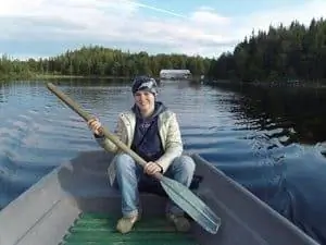 Мария гребет на лодке на Соловецких островах, Россия.
