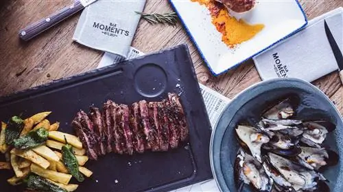 Столик в Moments Bar с антрекотом в сопровождении картофеля и перца, тарелкой осьминогов и мидий. Столик в Moments Bar с антрекотом в сопровождении картофеля и перца, тарелкой осьминогов и мидий.