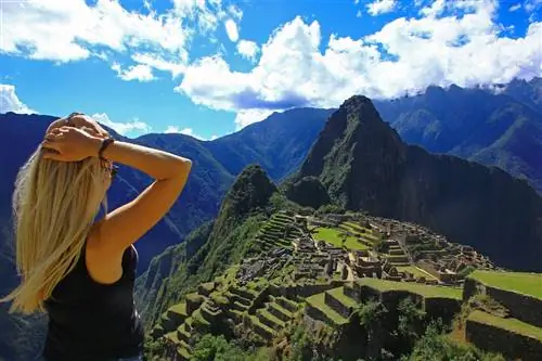 Молодая женщина смотрит на Мачу-Пикчу