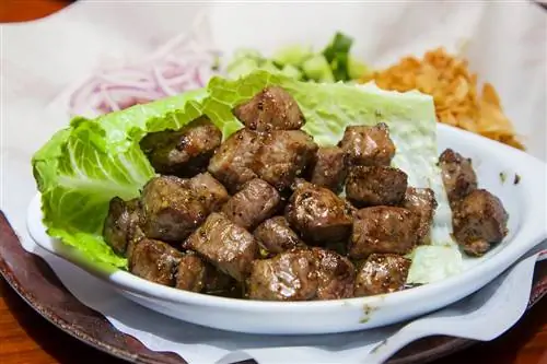 чесночные кубики говядины в листе салата
