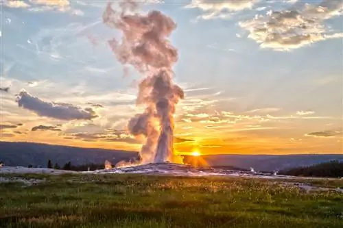 Извержение гейзера Old Faithful в Йеллоустонском национальном парке на закате