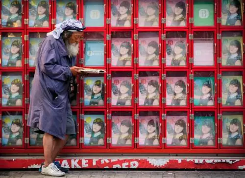 Одинокая фигура пересекает кладбище Окуноин в префектуре Вакаяма.