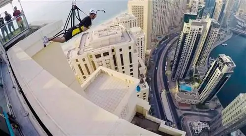 Человек собирается лететь на биплане среди зданий в Дубае